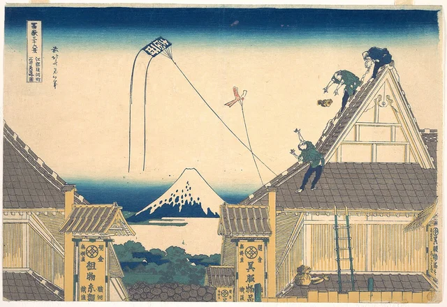 Katsushika Hokusai, Mitsui Shop at Surugacho in Edo. From the series Thirty-six Views of Mount Fuji, c. 1830–32. Colour woodblock print. The Mitsui flagship store with kite-flying workers on the roof and Mount Fuji visible in the background. Public domain.
